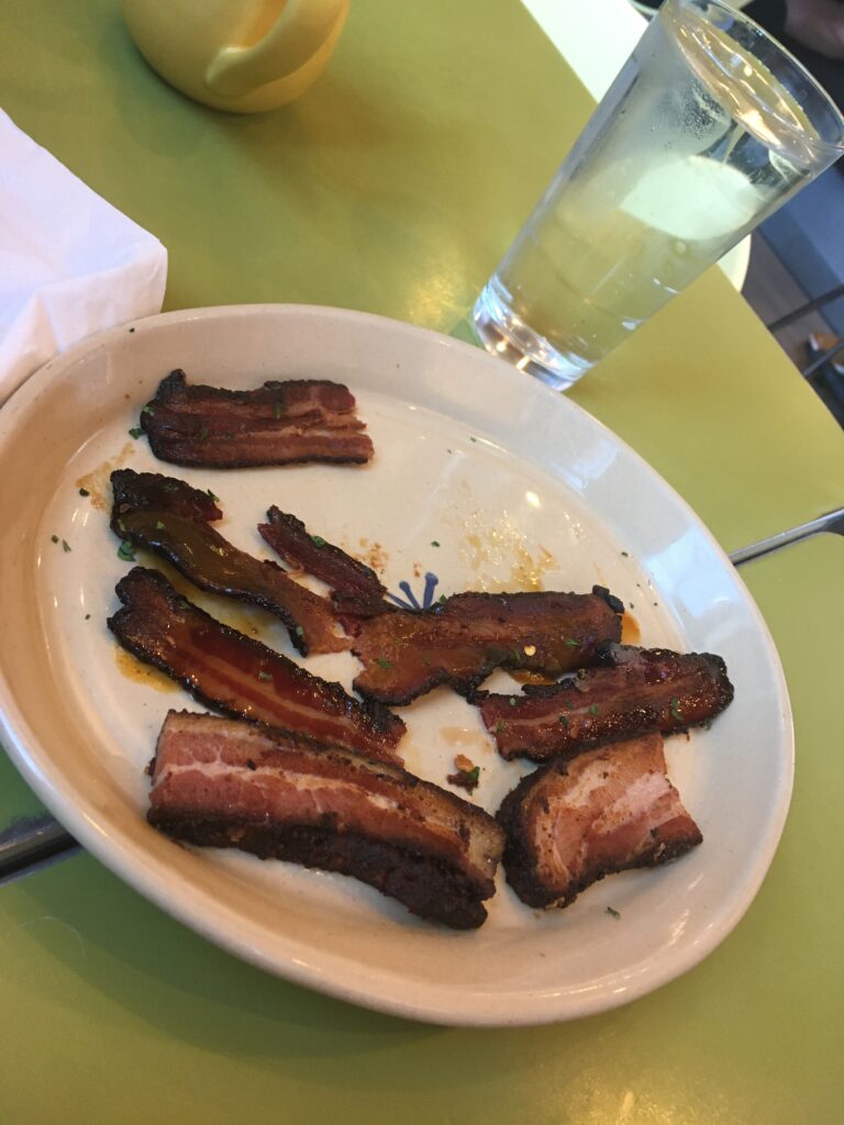 A flight of bacon on a plate