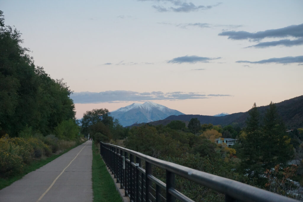 A walking path with a snow-covered mountain in the background