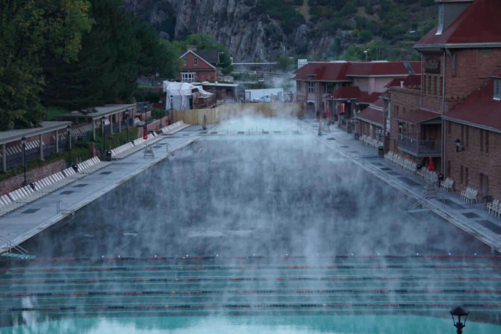 A view of the mineral hot springs swimming pool with steam rising from the water