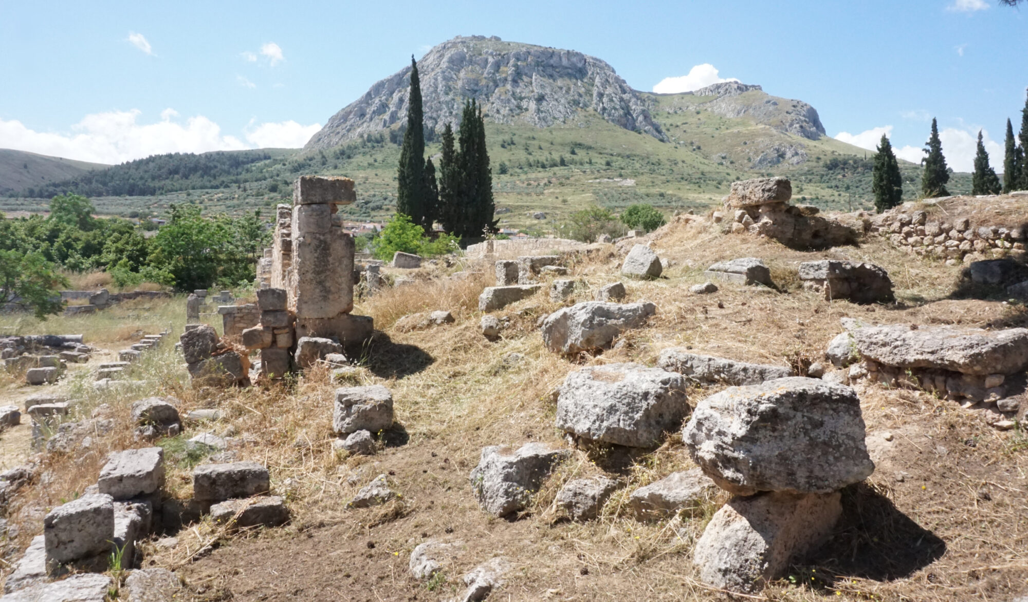 Ruins of ancient Corinth with a hill in the background